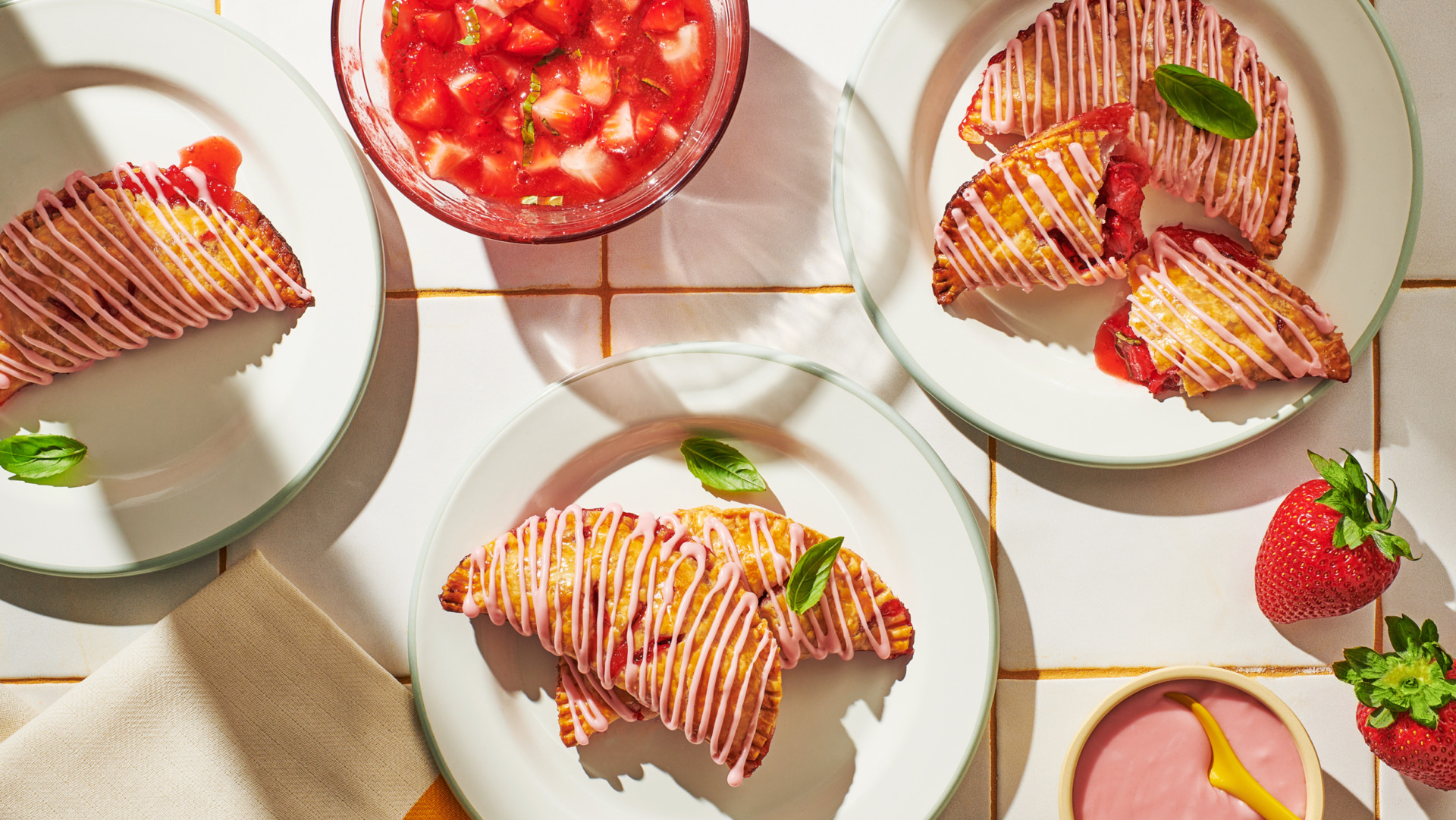 Image of Always Fresh strawberry basil hand pies on a plate with berry drizzle.